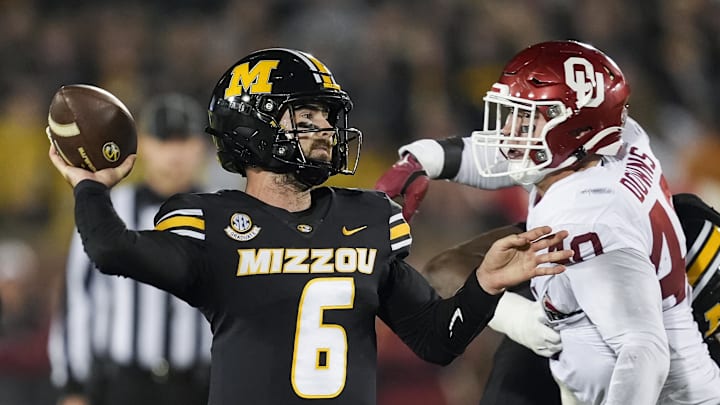 Nov 9, 2024; Columbia, Missouri, USA; Missouri Tigers quarterback Drew Pyne (6) throws a pass against Oklahoma Sooners defensive lineman Ethan Downs (40) during the second half at Faurot Field at Memorial Stadium. 