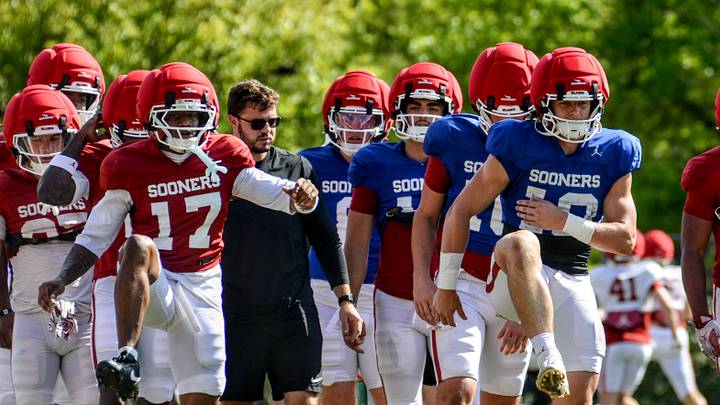 Oklahoma wide receiver Mackenzie Alleyne and quarterback John Mateer stretch during practice. Oklahoma wide receiver Mackenzie Alleyne and quarterback John Mateer stretch during practice.