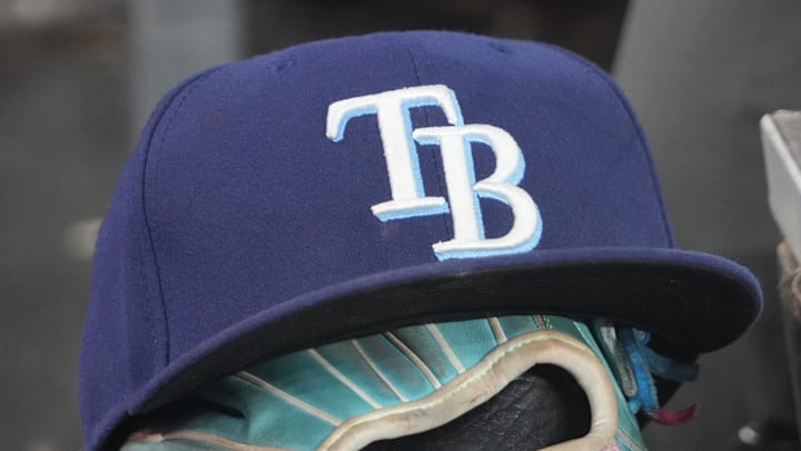 Sep 26, 2025; Toronto, Ontario, CAN; The hat and glove of Tampa Bay Rays third baseman Junior Caminero (13) in the dugout during the game against the Toronto Blue Jays at Rogers Centre. 