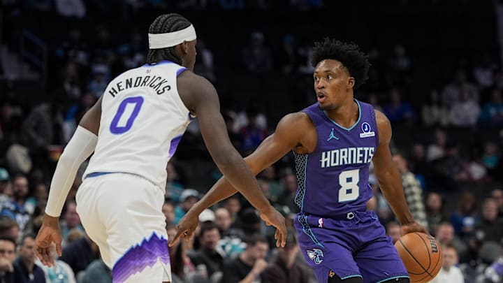Nov 2, 2025; Charlotte, North Carolina, USA; Charlotte Hornets guard Collin Sexton (8) sets the play defended by Utah Jazz forward Taylor Hendricks (0) during the first quarter at Spectrum Center. Mandatory Credit: Jim Dedmon-Imagn Images