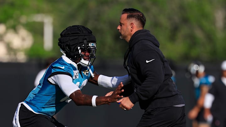 Jacksonville Jaguars wide receiver Travis Hunter (12), left, is pressured by defensive coordinator Anthony Campanile during an NFL training camp session at the Miller Electric Center, Sunday, Aug. 3, 2025, in Jacksonville, Fla. [Corey Perrine/Florida Times-Union]