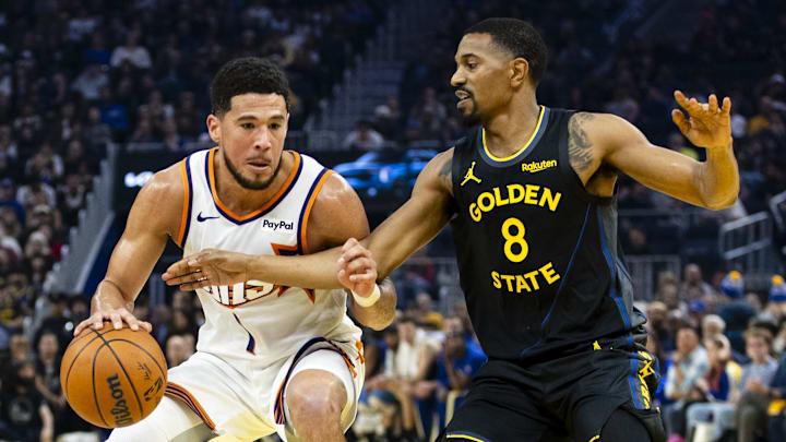 Dec 20, 2025; San Francisco, California, USA; Golden State Warriors guard De'Anthony Melton (8) defends Phoenix Suns guard Devin Booker (1) during the first quarter at Chase Center. Mandatory Credit: John Hefti-Imagn Images