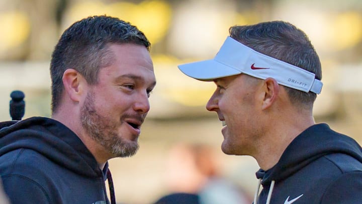 Oregon head coach Dan Lanning, left, and USC head coach Lincoln Riley shake hands before the game as the Oregon Ducks host the USC Trojans on Nov. 22, 2025, at Autzen Stadium in Eugene, Oregon.