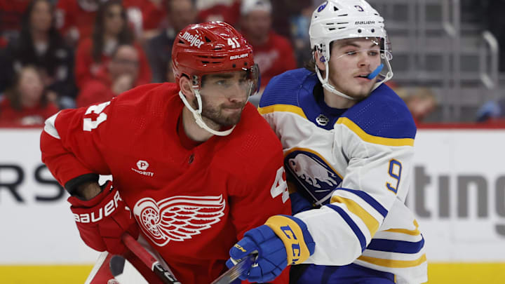 Apr 7, 2024; Detroit, Michigan, USA; Detroit Red Wings defenseman Shayne Gostisbehere (41) and Buffalo Sabres left wing Zach Benson (9) fight for position in the third period at Little Caesars Arena. Mandatory Credit: Rick Osentoski-Imagn Images