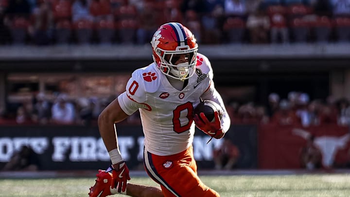 Dec 21, 2024; Austin, Texas, USA; Clemson receiver Antonio Williams (0) runs the ball against the Texas Longhorns in the first round of the College Football Playoffs at Darrell K Royal-Texas Memorial Stadium. Mandatory Credit: Aaron E. Martinez/USA Today Network via Imagn Images Dec 21, 2024; Austin, Texas, USA; Clemson receiver Antonio Williams (0) runs the ball against the Texas Longhorns in the first round of the College Football Playoffs at Darrell K Royal-Texas Memorial Stadium. Mandatory Credit: Aaron E. Martinez/USA Today Network via Imagn Images