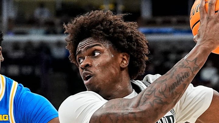 Michigan State forward Coen Carr (55) goes to the basket against UCLA center Xavier Booker (1) during the second half of Big Ten tournament quarterfinal at United Center in Chicago on Friday, March 13, 2026.
