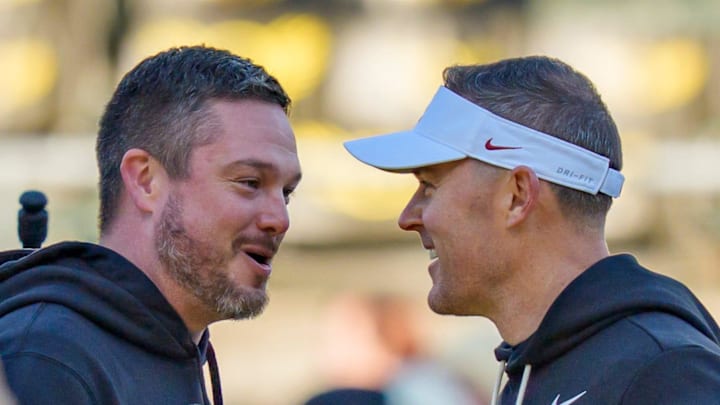 Oregon head coach Dan Lanning, left, and USC head coach Lincoln Riley shake hands before the game as the Oregon Ducks host the USC Trojans on Nov. 22, 2025, at Autzen Stadium in Eugene, Oregon.