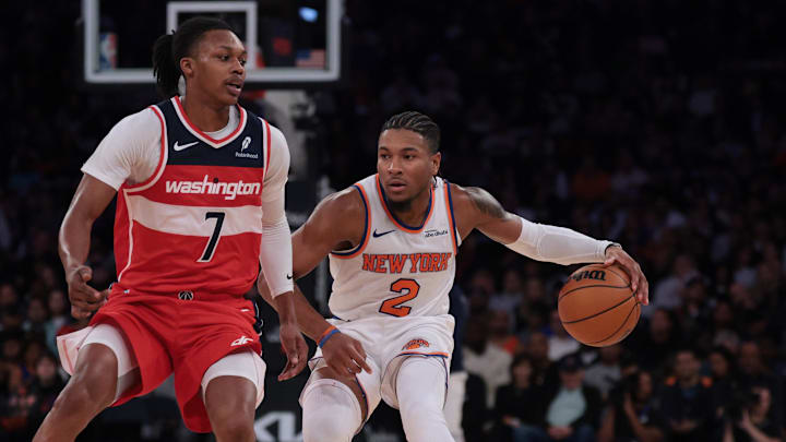 Oct 13, 2025; New York, New York, USA; New York Knicks guard Miles McBride (2) dribbles up court against Washington Wizards guard Bub Carrington (7) during the first half at Madison Square Garden. Mandatory Credit: Vincent Carchietta-Imagn Images