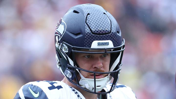 Seattle Seahawks quarterback Sam Darnold practices on the sideline