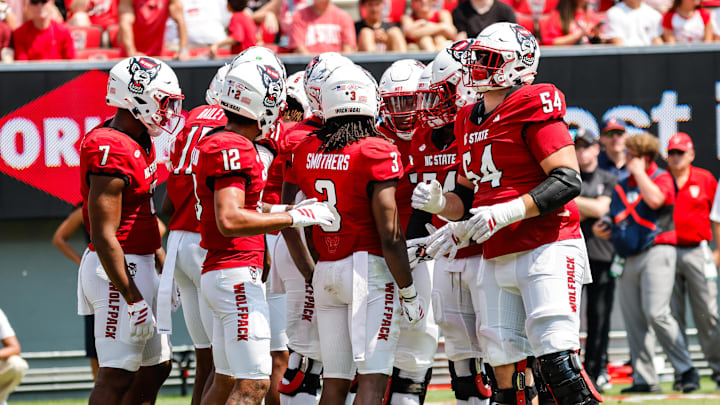 Sep 6, 2025; Raleigh, North Carolina, USA; North Carolina State Wolfpack huddle during the first half of the game against Virginia Cavaliers at Carter-Finley Stadium. Mandatory Credit: Jaylynn Nash-Imagn Images