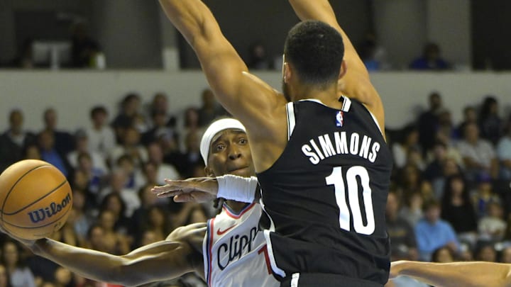 Oct 8, 2024; Oceanside, California, USA; Los Angeles Clippers guard Terance Mann (14) passes the ball around Brooklyn Nets guard Ben Simmons (10) in the first half at Frontwave Arena. Mandatory Credit: Jayne Kamin-Oncea-Imagn Images