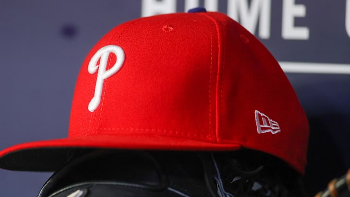 May 26, 2023; Atlanta, Georgia, USA; A detailed view of a Philadelphia Phillies hat and glove on the bench against the Atlanta Braves in the seventh inning at Truist Park. 