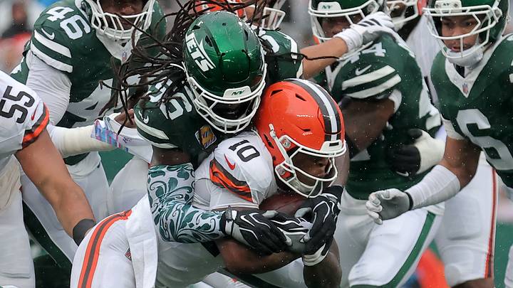 Cleveland Browns running back Quinshon Judkins meets a host of New York Jets defenders at the line of scrimmage.