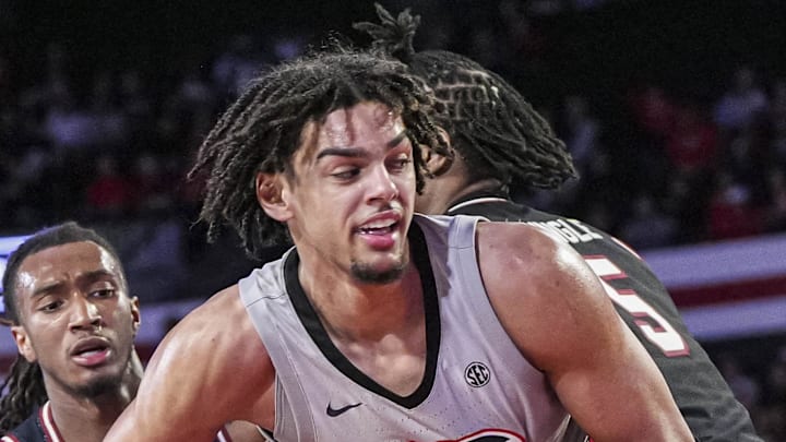 Jan 28, 2025; Athens, Georgia, USA; Georgia Bulldogs forward Asa Newell (14) grabs a rebound between South Carolina Gamecocks guard Zachary Davis (2) and forward Nick Pringle (5) during the second half at Stegeman Coliseum. Mandatory Credit: Dale Zanine-Imagn Images
