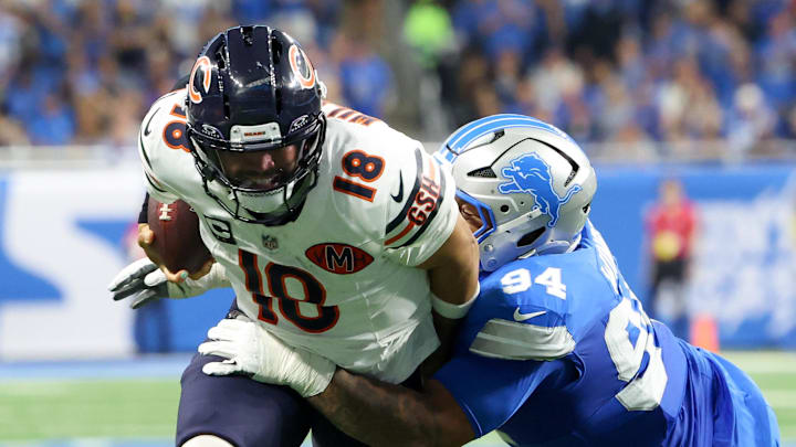 Detroit Lions defensive tackle Mekhi Wingo (94) tackles Chicago Bears quarterback Caleb Williams (18) 