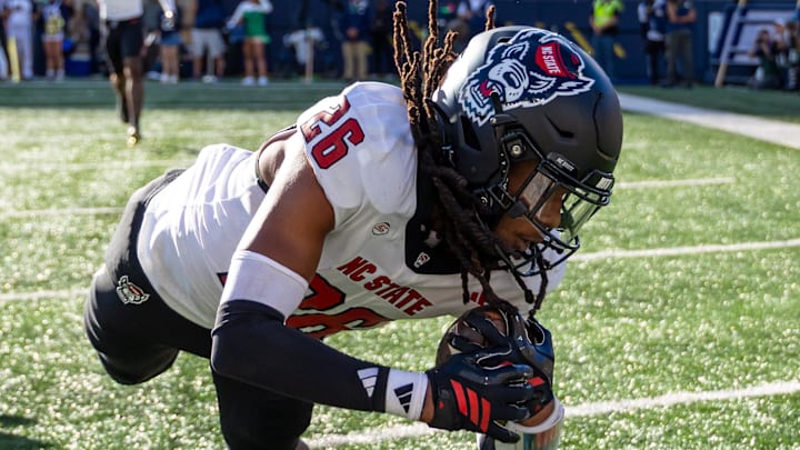 Oct 11, 2025; South Bend, Indiana, USA; NC State Wolfpack defensive back Asaad Brown Jr. (26) intercepts a pass in the end zone against the Notre Dame Fighting Irish during the first half at Notre Dame Stadium. Mandatory Credit: Michael Caterina-Imagn Images