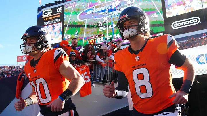 Denver Broncos quarterback Bo Nix (10) and Jarrett Stidham (8) run out for player 