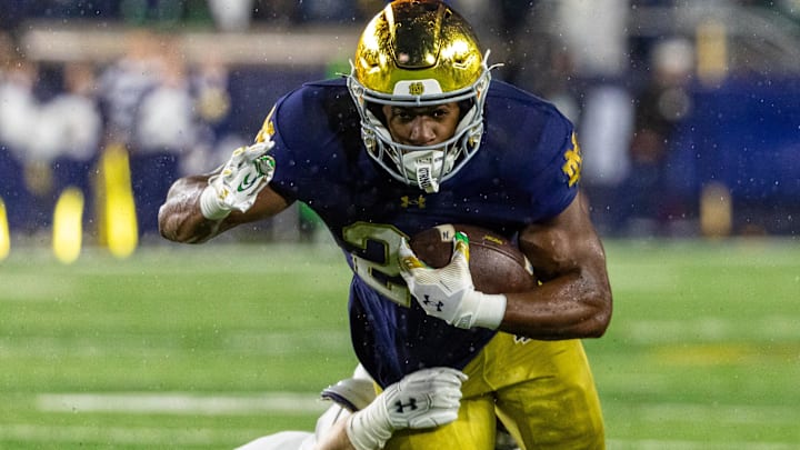 Nov 8, 2025; South Bend, Indiana, USA; Notre Dame Fighting Irish running back Jadarian Price (24) gets tackled by Navy Midshipmen linebacker Coleman Cauley (58) during the first half at Notre Dame Stadium. 