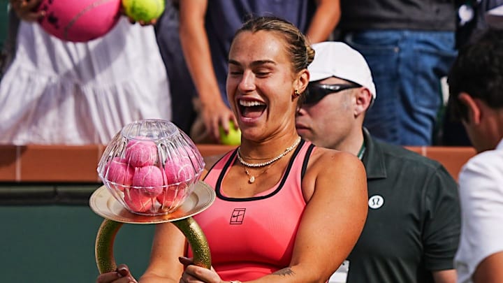 Aryna Sabalenka reacts to receiving a large homemade novelty engagement ring