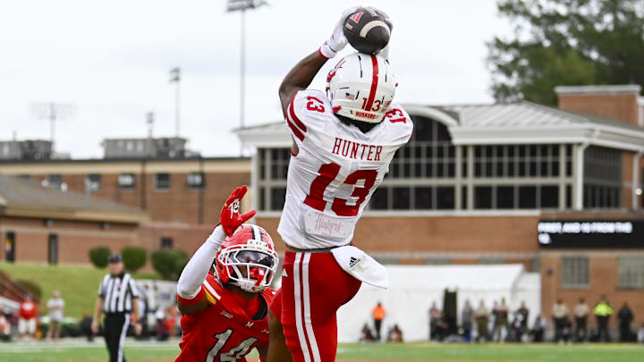Nyziah Hunter leaps over Maryland Terrapins defensive back Jamare Glasker for a touchdown.