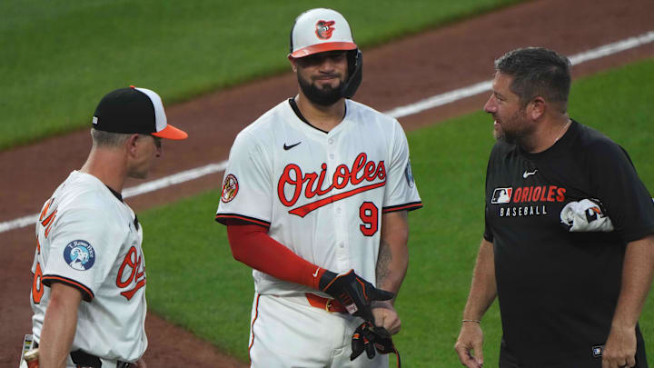 Jun 23, 2025; Baltimore, Maryland, USA; Baltimore Orioles designated hitter Gary Sanchez (99) is visited by manager Tony Mansolino (left) and training staff (right) after being hit by a pitch during the seventh inning against the Texas Rangers at Oriole Park at Camden Yards. Jun 23, 2025; Baltimore, Maryland, USA; Baltimore Orioles designated hitter Gary Sanchez (99) is visited by manager Tony Mansolino (left) and training staff (right) after being hit by a pitch during the seventh inning against the Texas Rangers at Oriole Park at Camden Yards.