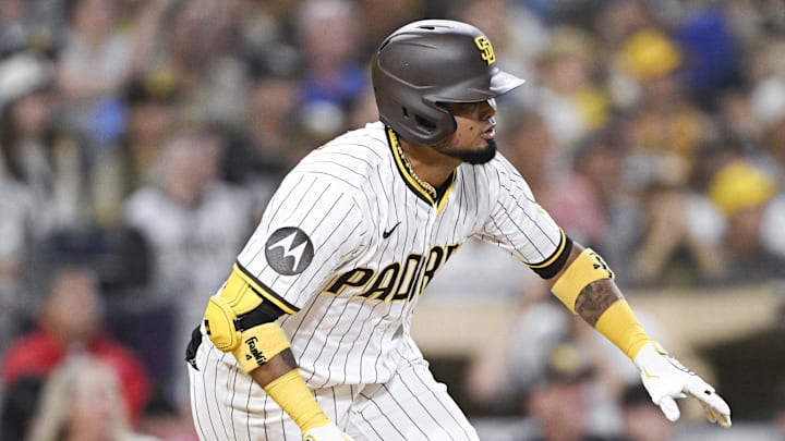 Sep 22, 2025; San Diego, California, USA; San Diego Padres first baseman Luis Arraez (4) hits an RBI single during the seventh inning against the Milwaukee Brewers at Petco Park. Mandatory Credit: Denis Poroy-Imagn Images