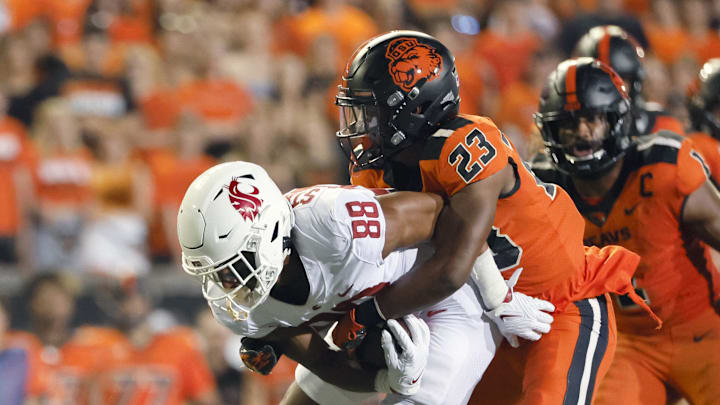 Oct 15, 2022; Corvallis, Oregon, USA; Washington State Cougars wide receiver De'Zhaun Stribling (88) is brought down by Oregon State Beavers defensive back Ryan Cooper Jr. (23) during the first half at Reser Stadium. Mandatory Credit: Soobum Im-Imagn Images Oct 15, 2022; Corvallis, Oregon, USA; Washington State Cougars wide receiver De'Zhaun Stribling (88) is brought down by Oregon State Beavers defensive back Ryan Cooper Jr. (23) during the first half at Reser Stadium. Mandatory Credit: Soobum Im-Imagn Images