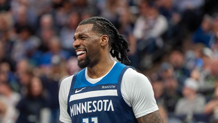 Apr 13, 2025; Minneapolis, Minnesota, USA; Minnesota Timberwolves center Naz Reid (11) laughs with a teammate during a stoppage in the fourth quarter against the Utah Jazz at Target Center. Mandatory Credit: Matt Blewett-Imagn Images