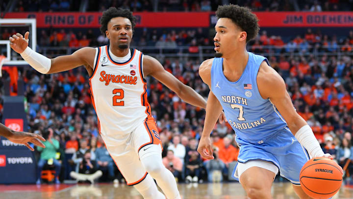 Feb 21, 2026; Syracuse, New York, USA; North Carolina Tar Heels guard Seth Trimble (7) drives against Syracuse Orange guard J.J. Starling (2) during the first half at the JMA Wireless Dome. Mandatory Credit: Rich Barnes-Imagn Images