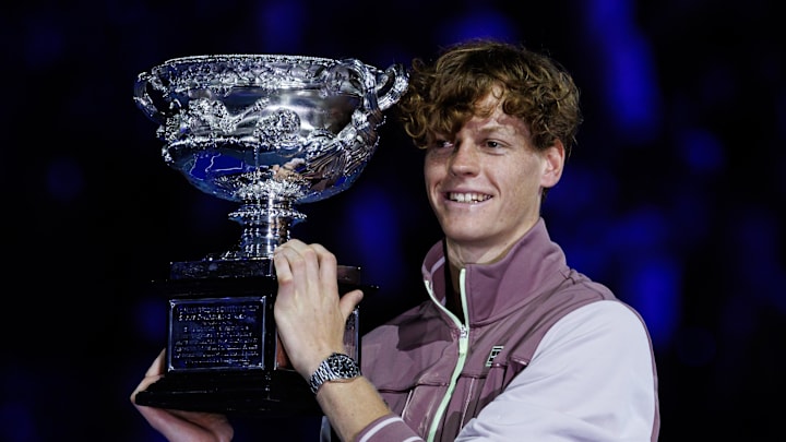 Jannik Sinner holds the trophy at the 2024 Australian Open.