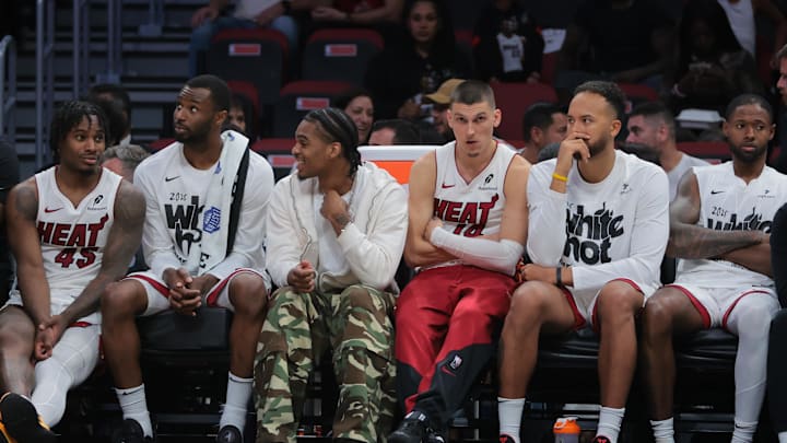 Apr 28, 2025; Miami, Florida, USA; Miami Heat guard Tyler Herro (center) looks on from the bench against the Cleveland Cavaliers in the fourth quarter during game four for the first round of the 2025 NBA Playoffs at Kaseya Center. Mandatory Credit: Sam Navarro-Imagn Images