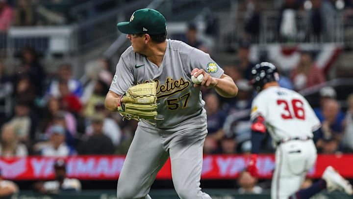 Mar 30, 2026; Cumberland, Georgia, USA; Athletics pitcher Jacob Lopez (57) throws the ball to first base for an out against the Atlanta Braves during the third inning at Truist Park. Mandatory Credit: Jordan Godfree-Imagn Images