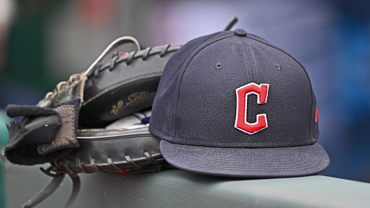 Jun 27, 2024; Kansas City, Missouri, USA; A general view a Cleveland Guardians hat and glove on the dugout railing  before a game against the Kansas City Royals at Kauffman Stadium. 