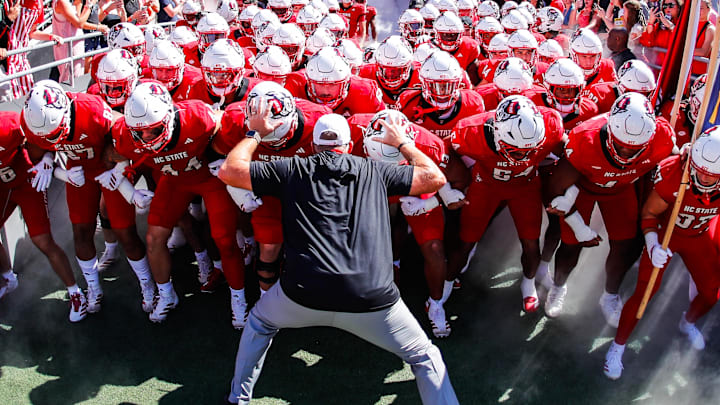 Oct 4, 2025; Raleigh, North Carolina, USA;  NC State Wolfpack head coach Dave Doeren with his team prepare to run out prior to the first half of the game against Campbell Fighting Camels at Carter-Finley Stadium. Mandatory Credit: Jaylynn Nash-Imagn Images