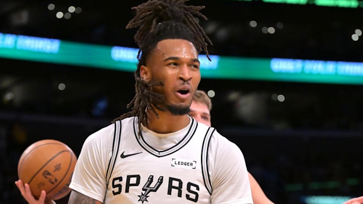 Dec 10, 2025; Los Angeles, California, USA;  San Antonio Spurs guard Stephon Castle (5) reats after a basket and a foul called on Los Angeles Lakers guard Luka Doncic (77) during the first half at Crypto.com Arena. Mandatory Credit: Jayne Kamin-Oncea-Imagn Images