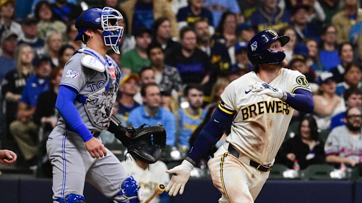 Apr 15, 2026; Milwaukee, Wisconsin, USA;  Milwaukee Brewers second baseman Brice Turang (2) drives in the go-ahead run with a groundout in the eighth inning as Toronto Blue Jays catcher Brandon Valenzuela (59) looks on at American Family Field. Mandatory Credit: Benny Sieu-Imagn Images