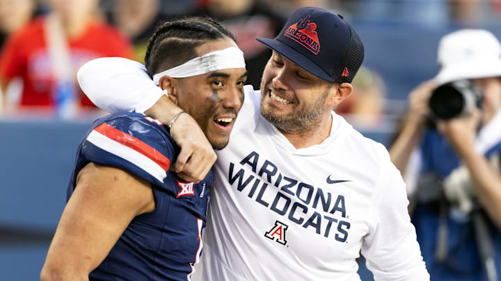 Nov 8, 2025; Tucson, Arizona, USA; Arizona Wildcats quarterback Noah Fifita (1) celebrates with offensive coordinator Seth Doege after defeating the Kansas Jayhawks at Arizona Stadium. Mandatory Credit: Mark J. Rebilas-Imagn Images Nov 8, 2025; Tucson, Arizona, USA; Arizona Wildcats quarterback Noah Fifita (1) celebrates with offensive coordinator Seth Doege after defeating the Kansas Jayhawks at Arizona Stadium. Mandatory Credit: Mark J. Rebilas-Imagn Images