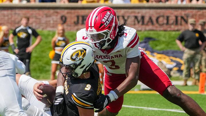 Missouri Tigers quarterback Beau Pribula (9) is sacked by Louisiana-Lafayette Ragin Cajuns linebacker Jaden Dugger (3)