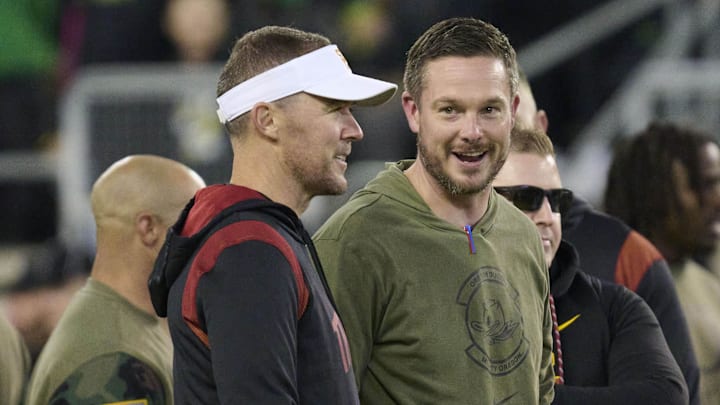 Nov 11, 2023; Eugene, Oregon, USA; USC Trojans head coach Lincoln Riley, left, and Oregon Ducks head coach Dan Lanning talk before a game at Autzen Stadium. Mandatory Credit: Troy Wayrynen-Imagn Images