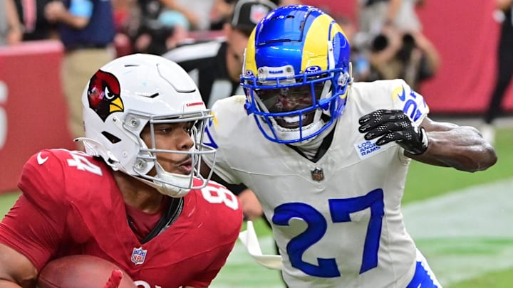 Sep 15, 2024; Glendale, Arizona, USA;  Arizona Cardinals tight end Elijah Higgins (84) catches a touchdown  as Los Angeles Rams cornerback Tre'Davious White (27) defends in the first half at State Farm Stadium. Mandatory Credit: Matt Kartozian-Imagn Images