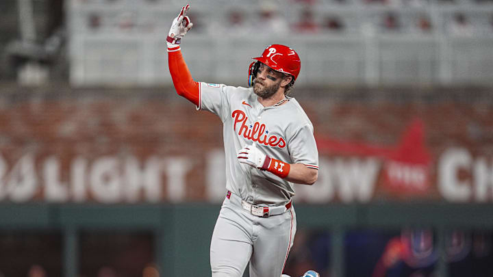 Apr 9, 2025; Cumberland, Georgia, USA; Philadelphia Phillies first base Bryce Harper (3) reacts while running the bases after hitting a two run home run against the Atlanta Braves during the seventh inning at Truist Park. 