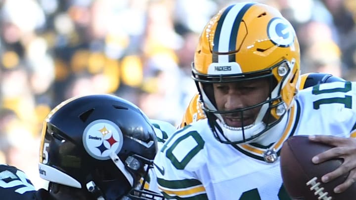 Green Bay Packers quarterback Jordan Love (10) gets sacked by Pittsburgh Steelers OLB T.J. Watt (90) and DT Keeanu Benton.