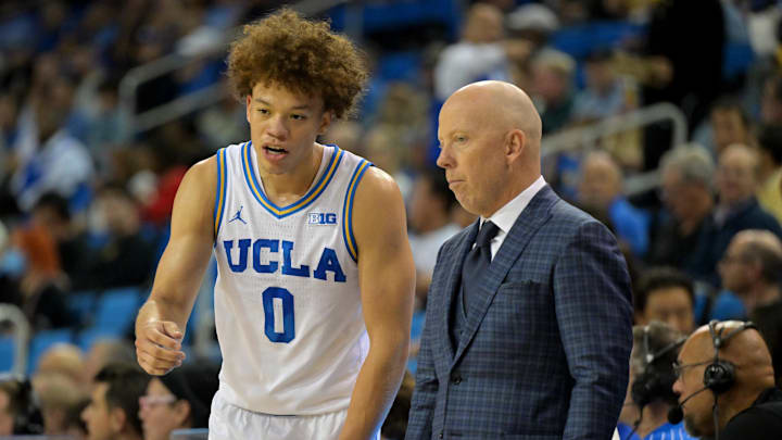 Nov 10, 2025; Los Angeles, California, USA;  UCLA Bruins guard Trent Perry (0) talks with head coach Mick Cronin during the first half against the West Georgia Wolves at Pauley Pavilion presented by Wescom Financial. Mandatory Credit: Jayne Kamin-Oncea-Imagn Images