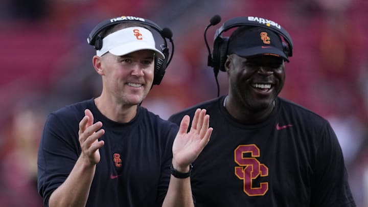 Sep 2, 2023; Los Angeles, California, USA; Southern California Trojans head coach Lincoln Riley (leff) and wide receivers coach Dennis Simmons react against the Nevada Wolf Pack in the second half at United Airlines Field at Los Angeles Memorial Coliseum. Mandatory Credit: Kirby Lee-Imagn Images