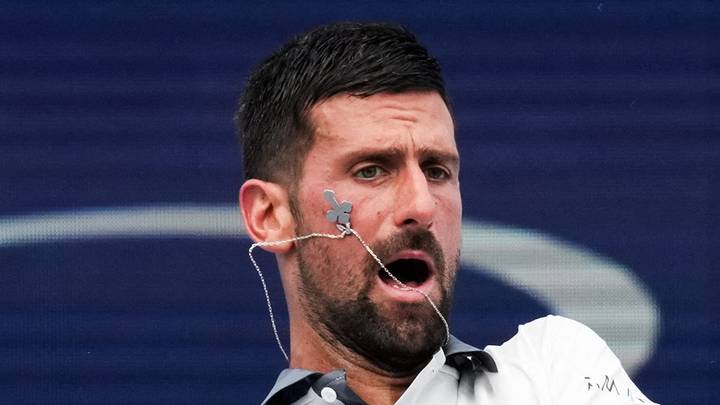 Novak Djokovic reacts after returning a shot Novak Djokovic reacts after returning a shot