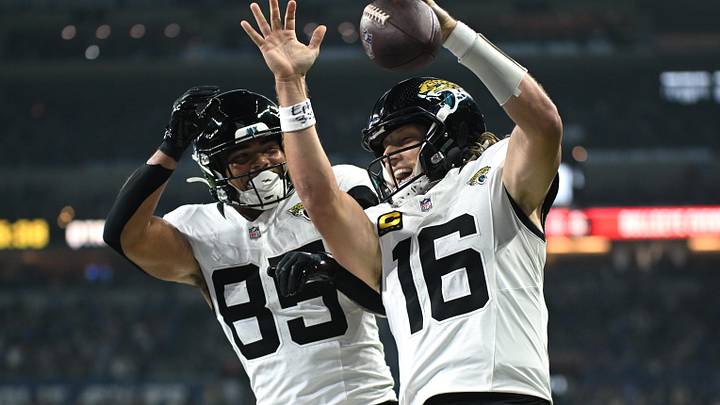 Dec 28, 2025; Indianapolis, Indiana, USA; Jacksonville Jaguars quarterback Trevor Lawrence (16) celebrates with tight end Brenton Strange (85) after a touchdown against the Indianapolis Colts during the first half at Lucas Oil Stadium. Mandatory Credit: Robert Goddin-Imagn Images