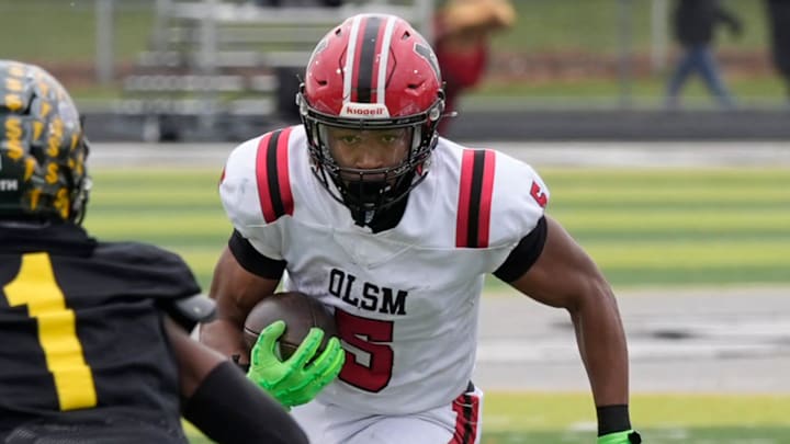 Orchard Lake St. Mary’s running back Darrin Jones eyes Birmingham Groves #1 Chris Little as he runs for extra yardage during first half action between the two schools in the MHSAA Division 2 semifinal game at West Bloomfield High School in West Bloomfield on Saturday, Nov. 23, 2024.
Orchard Lake St. Mary’s won the game 28-27 in one overtime.