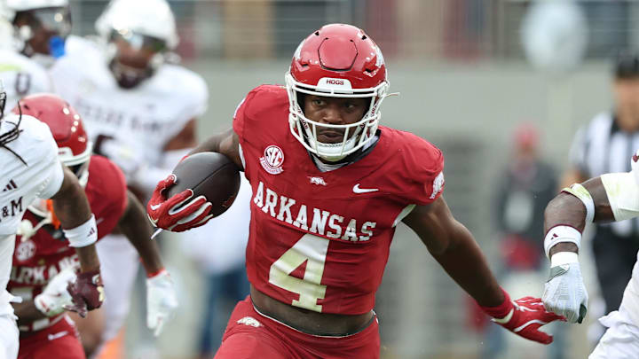 Oct 18, 2025; Fayetteville, Arkansas, USA; Arkansas Razorbacks running back Mike Washington Jr (4) rushes in the second quarter as Texas A&M Aggies cornerback Tyreek Chappell (7) and safety Dalton Brooks (25) defend at Donald W. Reynolds Razorback Stadium. Mandatory Credit: Nelson Chenault-Imagn Images Oct 18, 2025; Fayetteville, Arkansas, USA; Arkansas Razorbacks running back Mike Washington Jr (4) rushes in the second quarter as Texas A&M Aggies cornerback Tyreek Chappell (7) and safety Dalton Brooks (25) defend at Donald W. Reynolds Razorback Stadium. Mandatory Credit: Nelson Chenault-Imagn Images