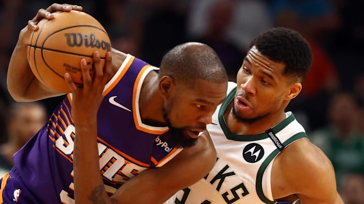 Milwaukee Bucks forward Giannis Antetokounmpo defends against Phoenix Suns forward Kevin Durant. Mandatory Credit: Mark J. Rebilas-Imagn Images