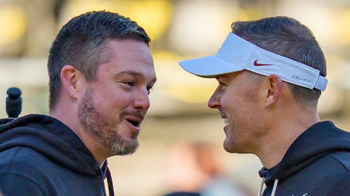Oregon head coach Dan Lanning, left, and USC head coach Lincoln Riley shake hands before the game as the Oregon Ducks host the USC Trojans on Nov. 22, 2025, at Autzen Stadium in Eugene, Oregon.